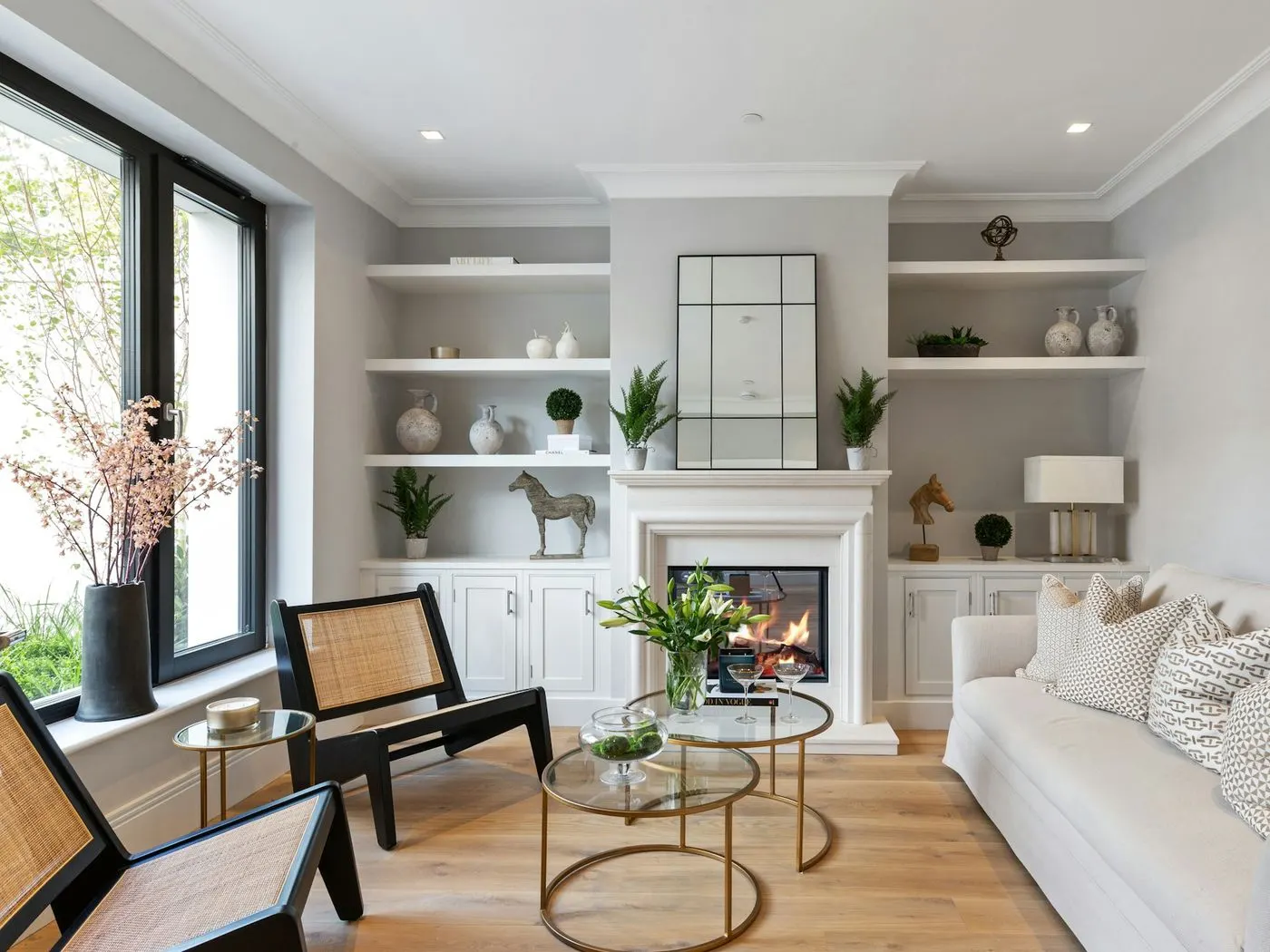 Clean living room with a fireplace and white built-in shelves