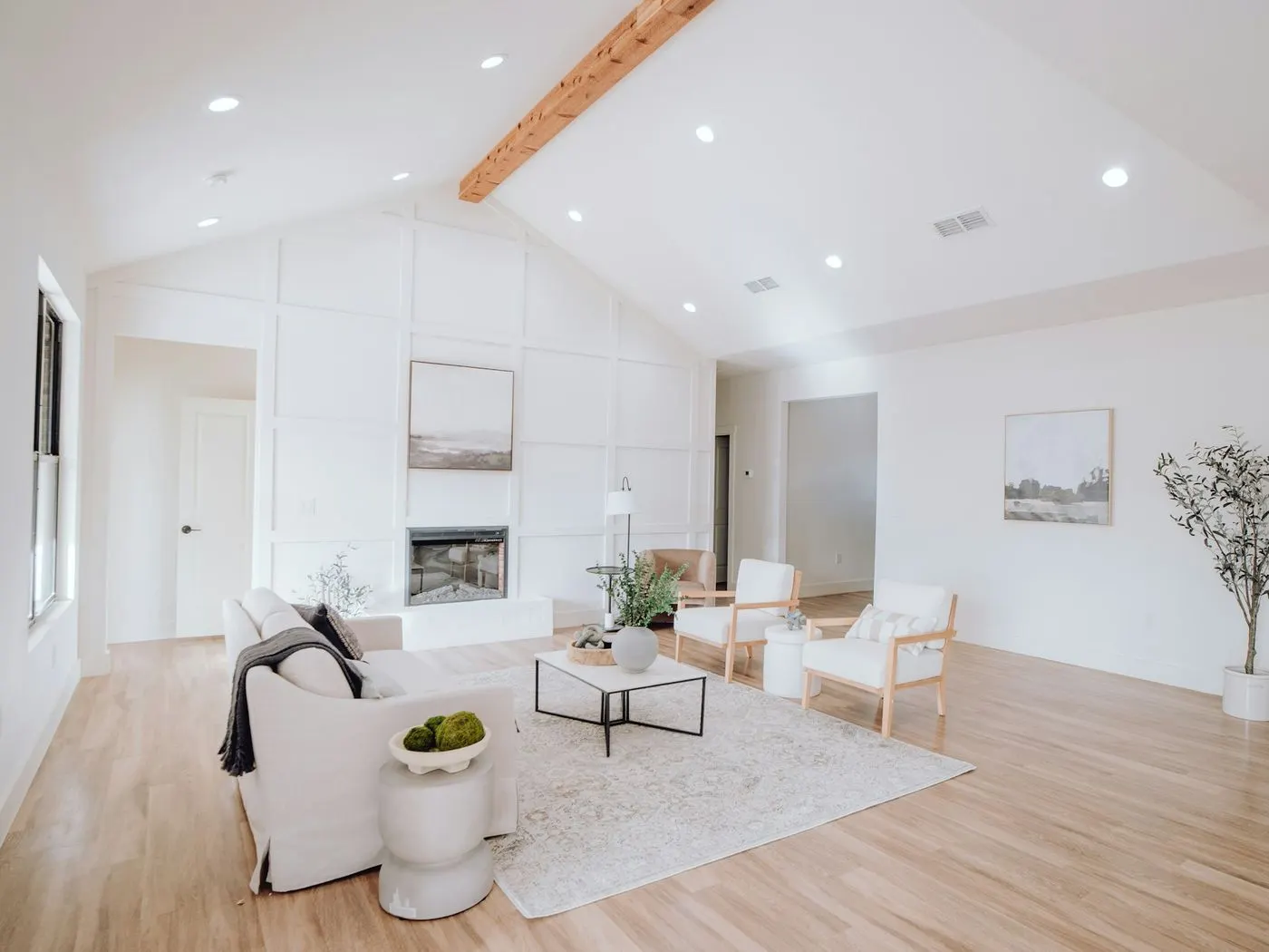 Wide, bright living room with white walls and a hardwood floor