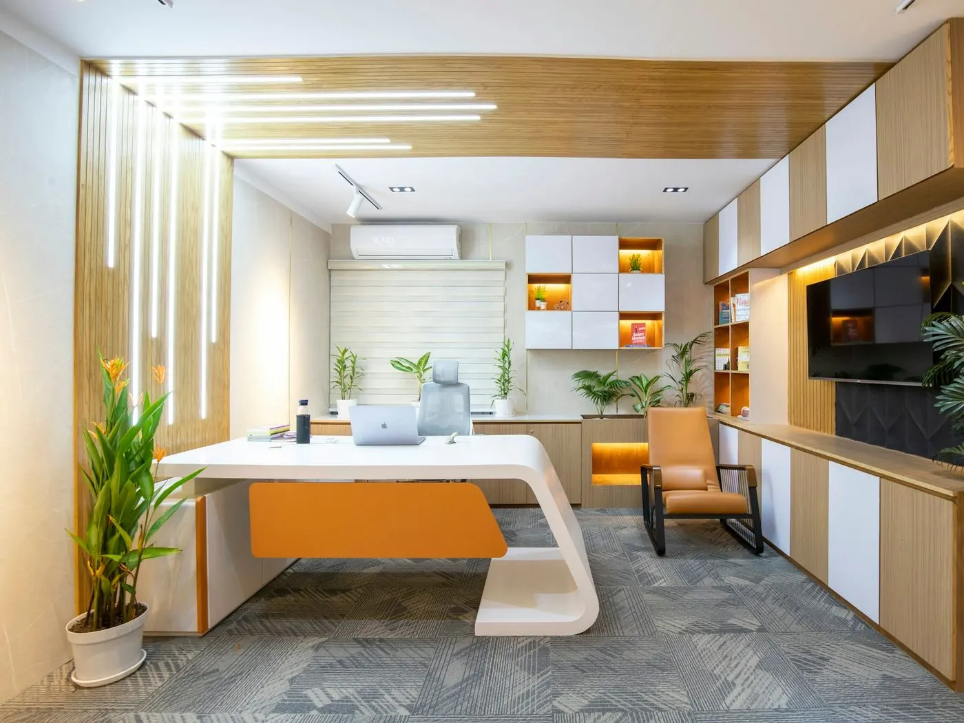 Small, tidy office with a white desk and plants